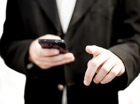 17744-business-man-holding-a-cell-phone-pv
